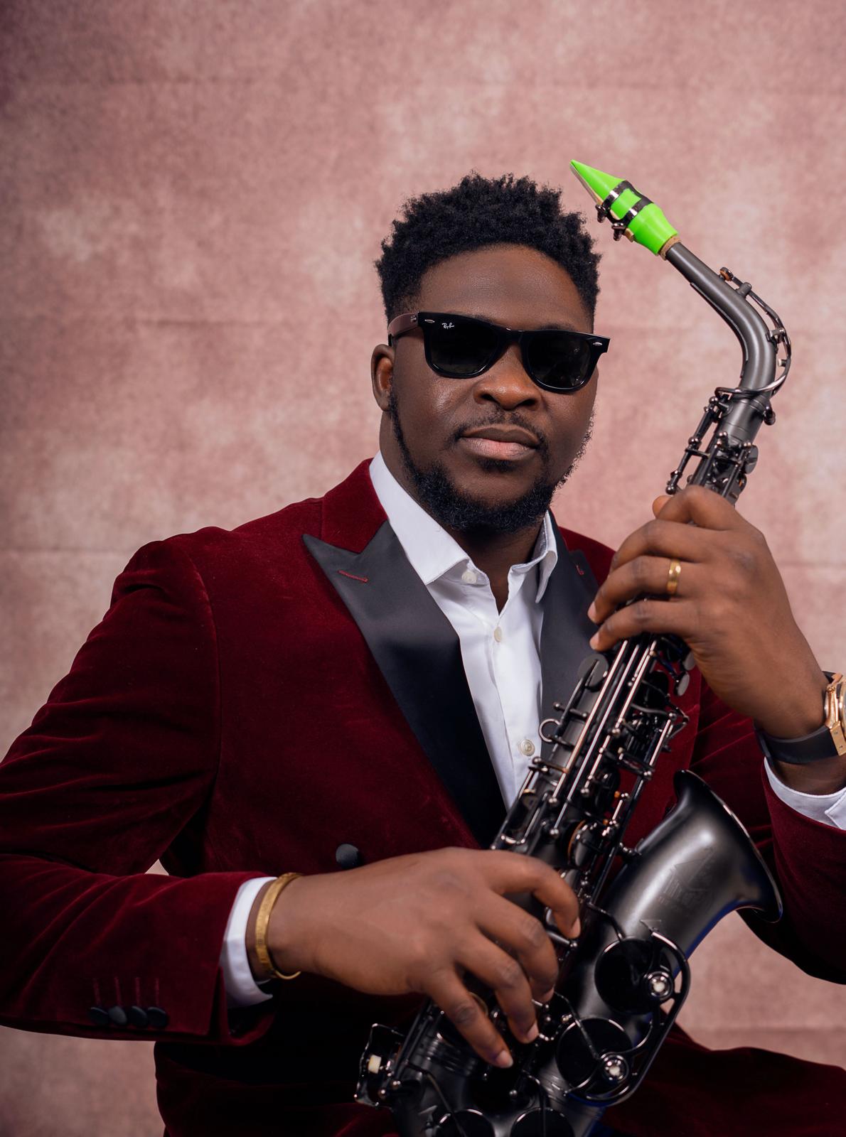 YomiSax wearing sunglasses with a black saxophone